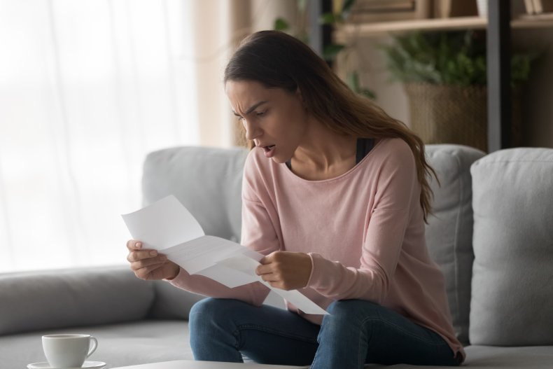 An angry woman reading a letter.