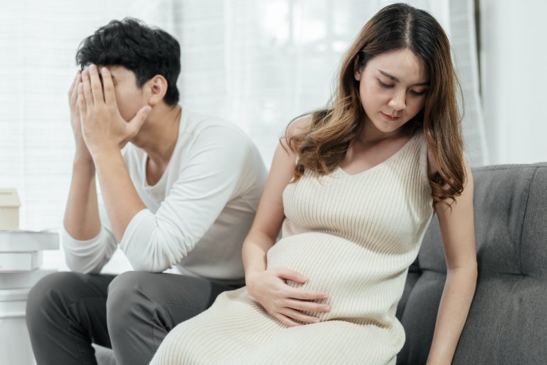 Man and pregnant wife ignoring each other