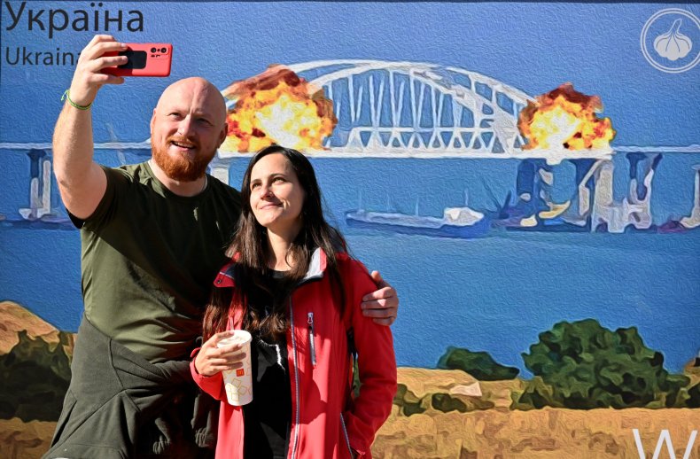 Couple with Crimea Bridge artwork in Kyiv