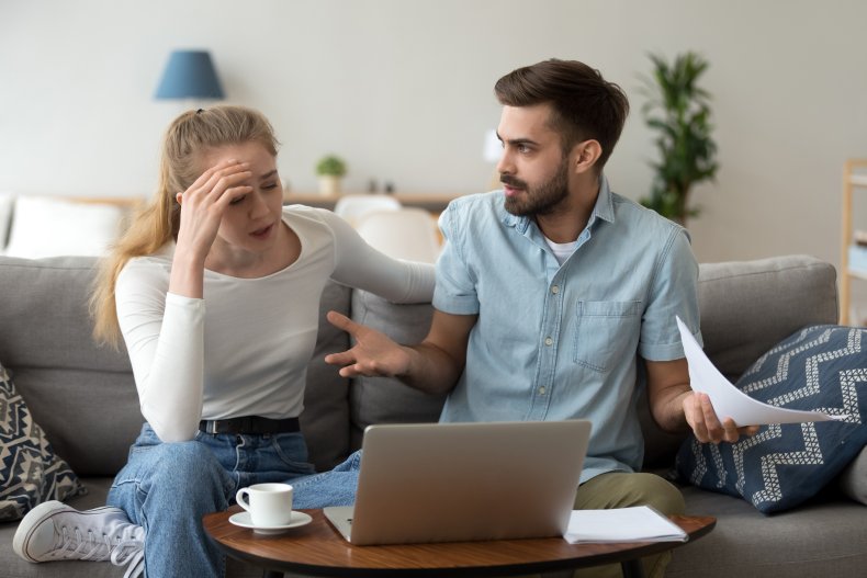 Young couple arguing in front of laptop