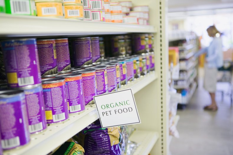Row of organic pet food cans.