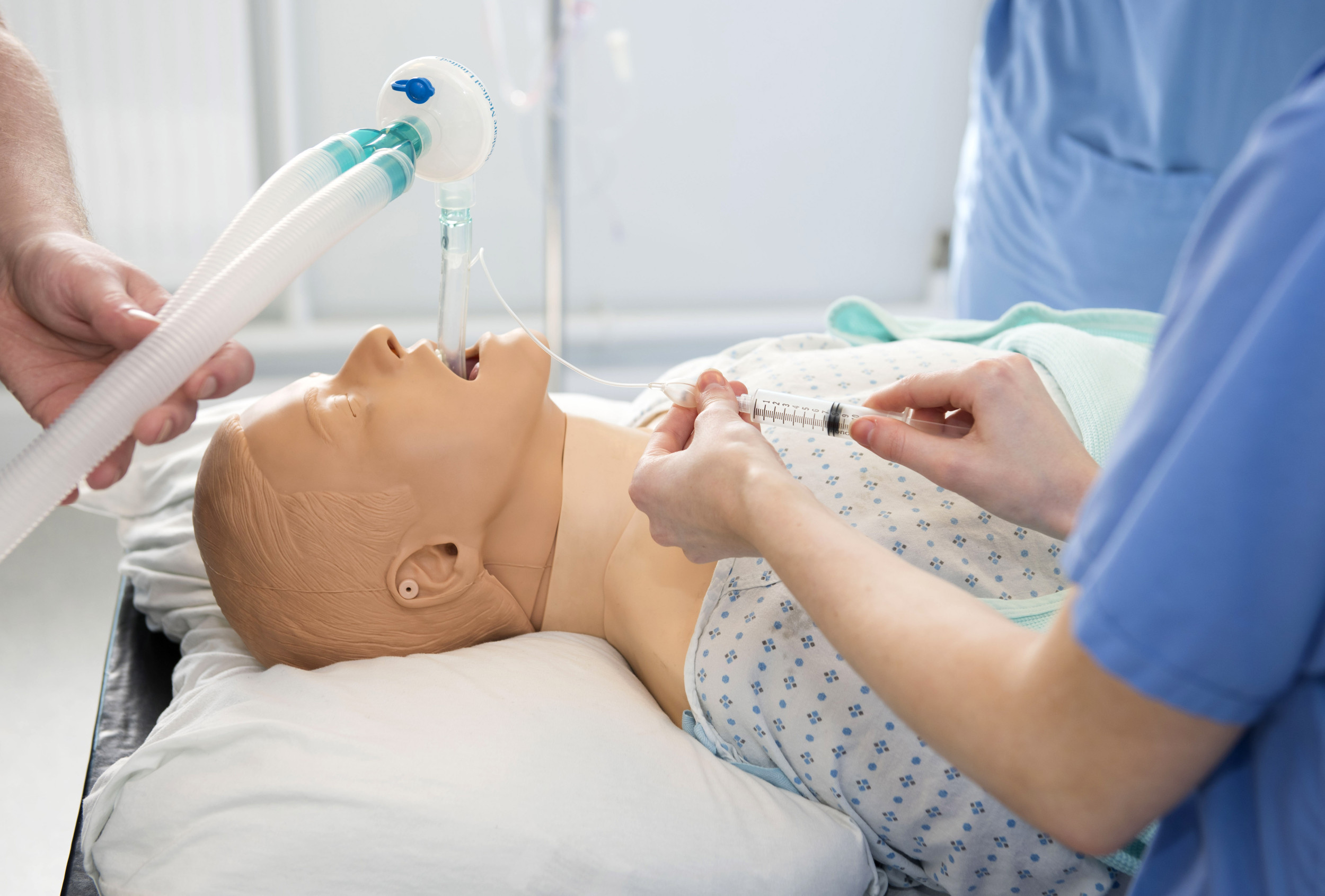 doctors training performing medical intubation