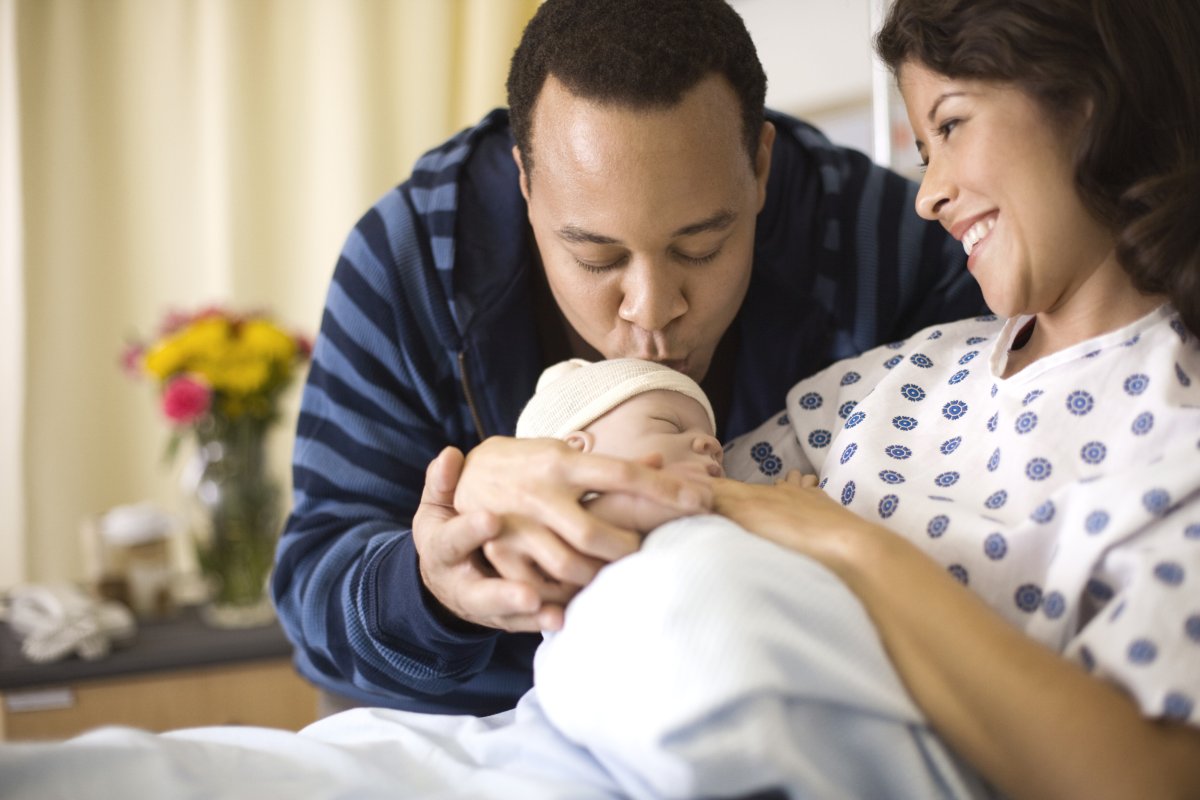Couple doting over a newborn in hospital.