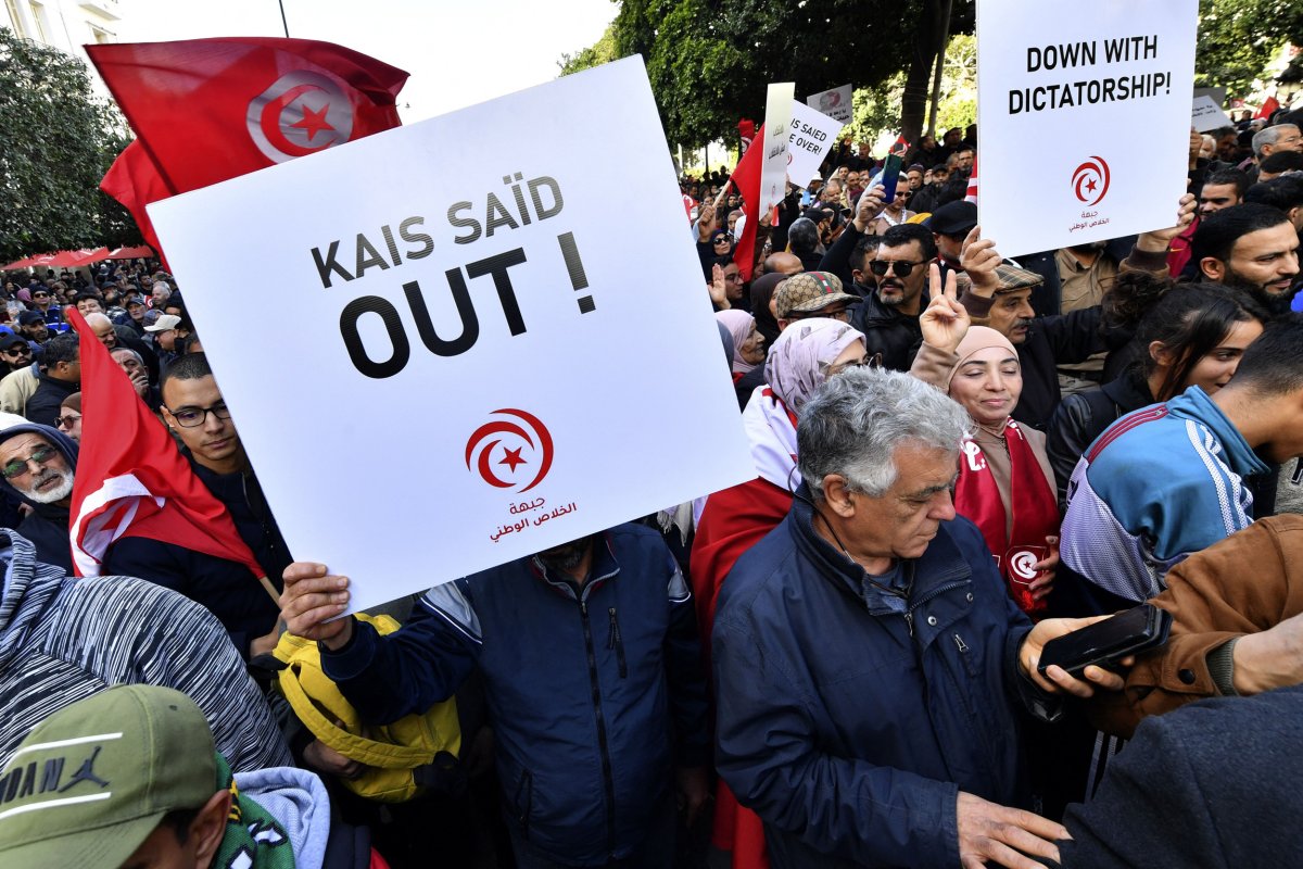 Tunisian demonstrators carry placards during a protest 