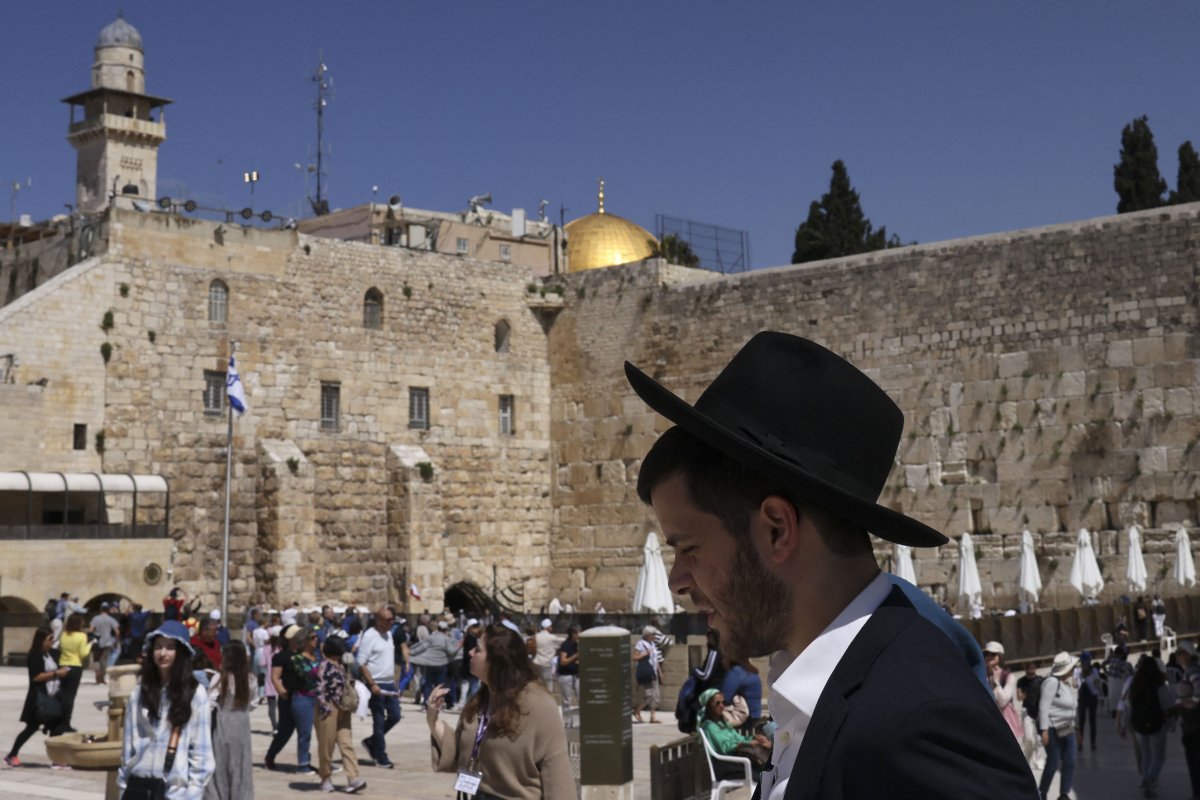 Jewish man walks amidst tourists at the