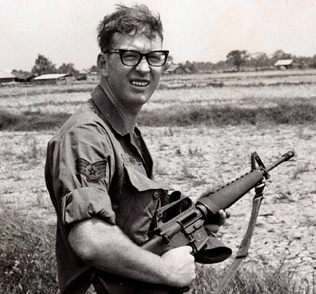 Robert Jack Adams holding gun in Vietnam