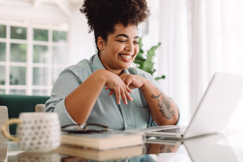 Woman smiling during a video call.