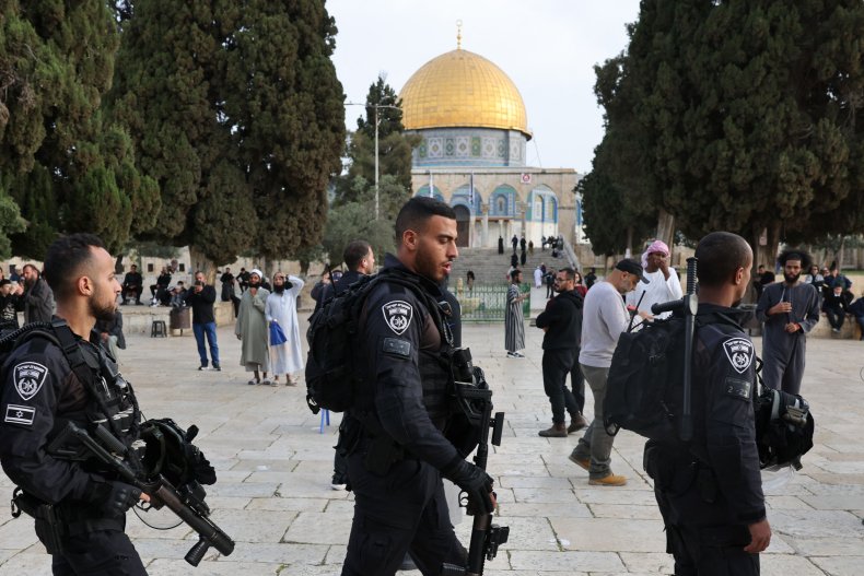 Jewish visitors walk protected by Israeli security