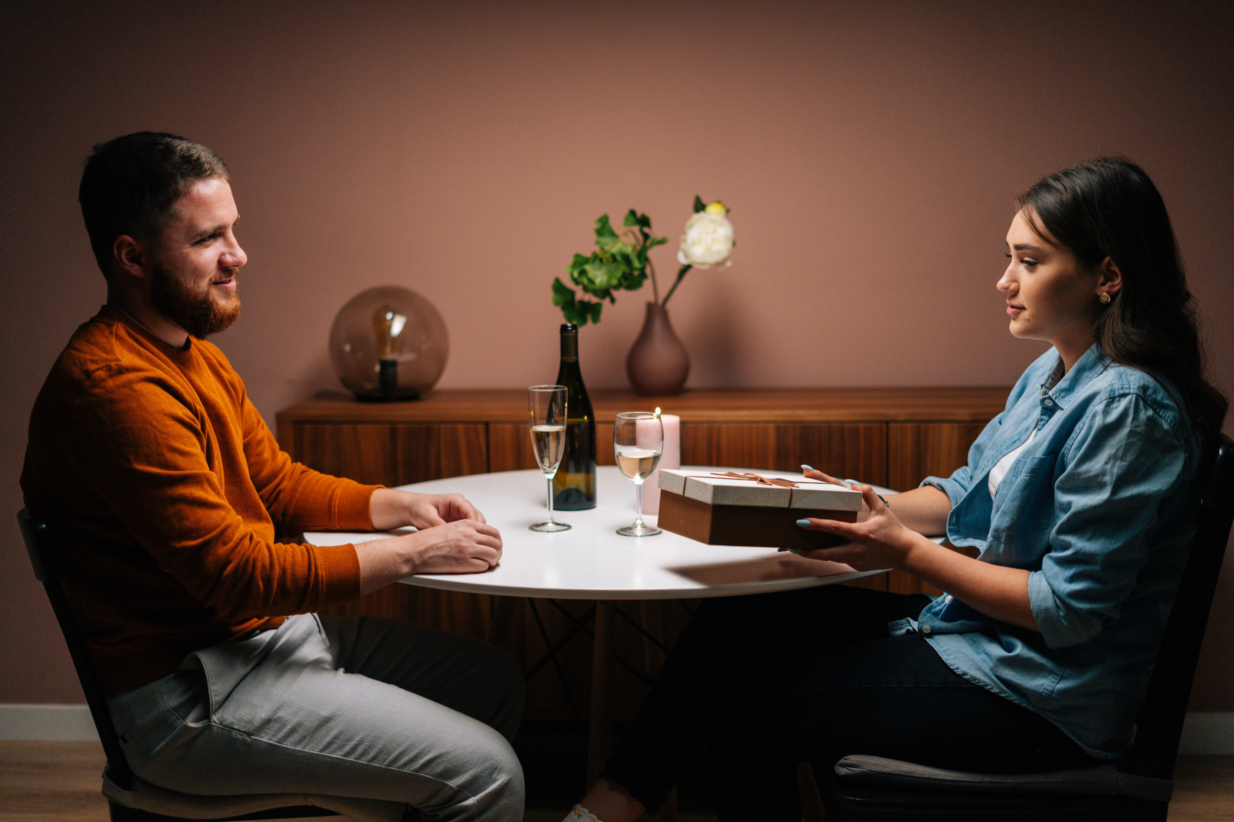 woman-handing-gift-man-table.jpg