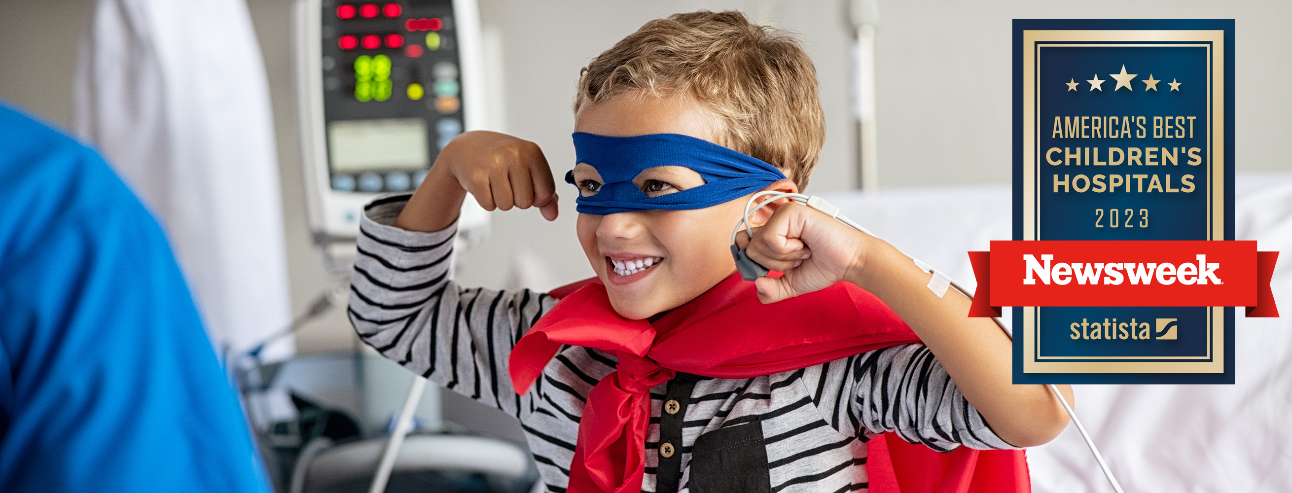 boy dressed as superhero in hospital bed