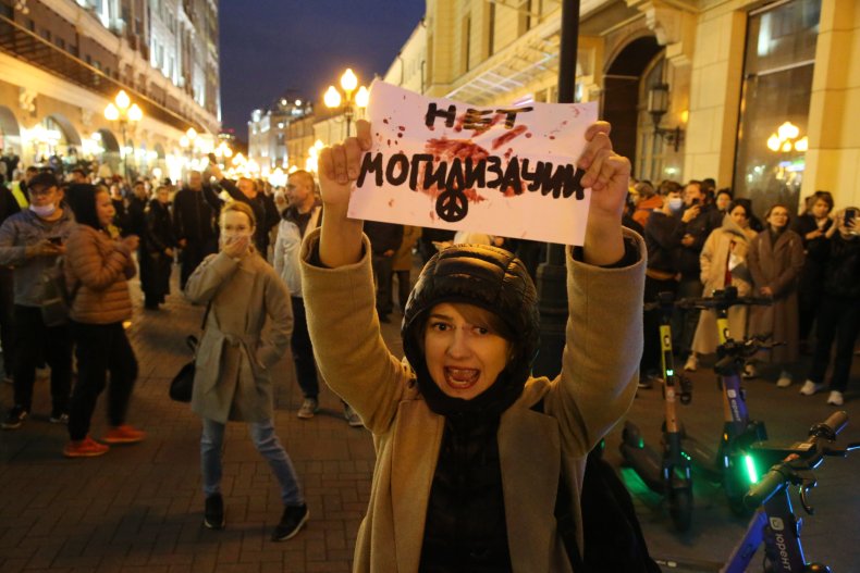 A female activist holding anti-mobilization poster