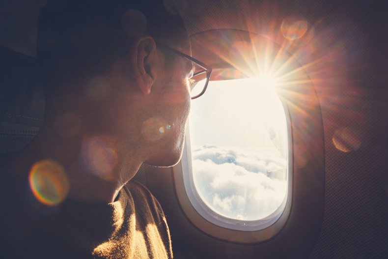 Man looking out the airplane window.
