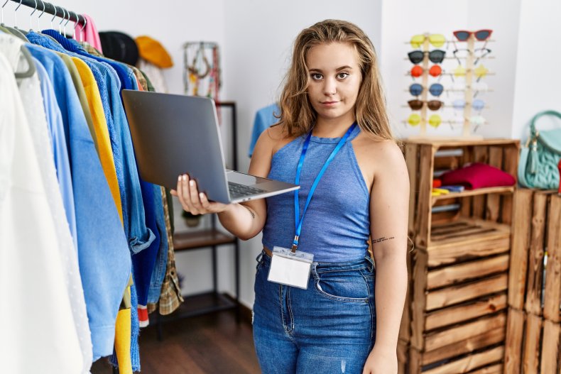 An unamused female retail worker