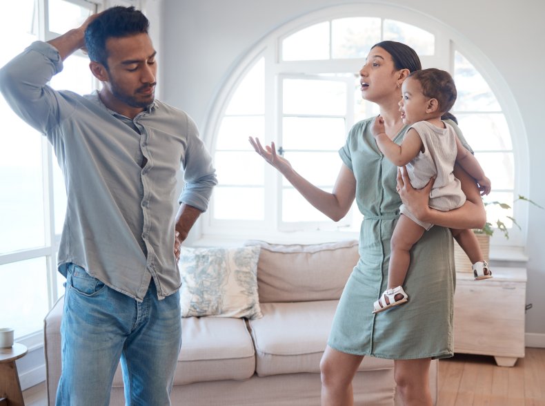 Couple arguing while the mom holds baby