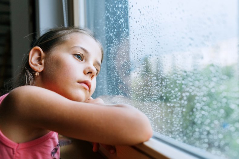 Sad girl looking out of the window