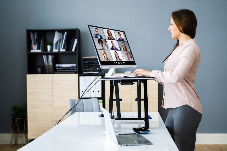 Woman using a standing desk during call.