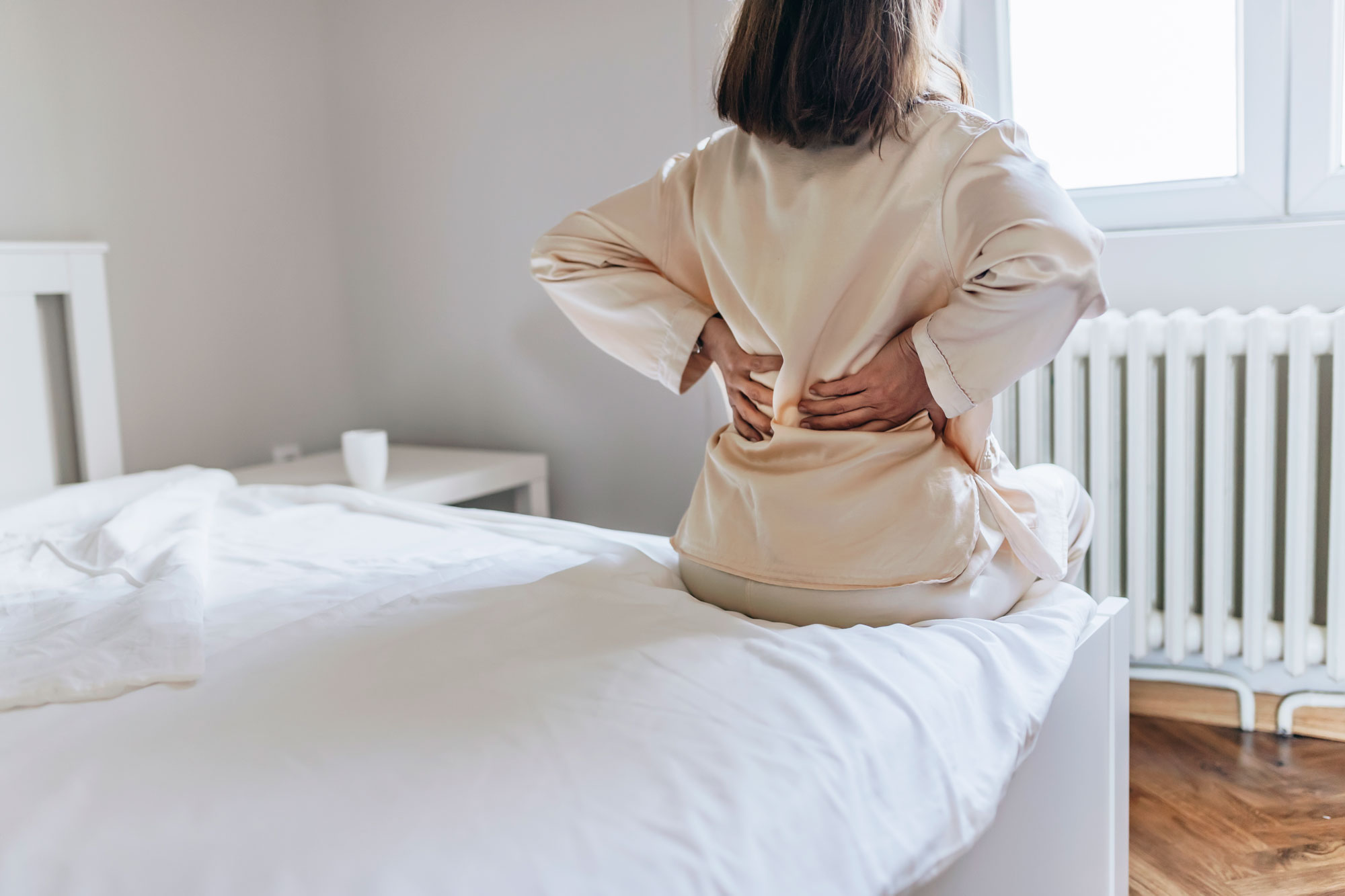 Woman with back Pain Bed