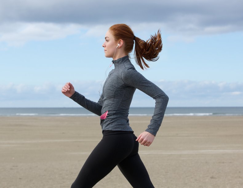Woman running on beach.