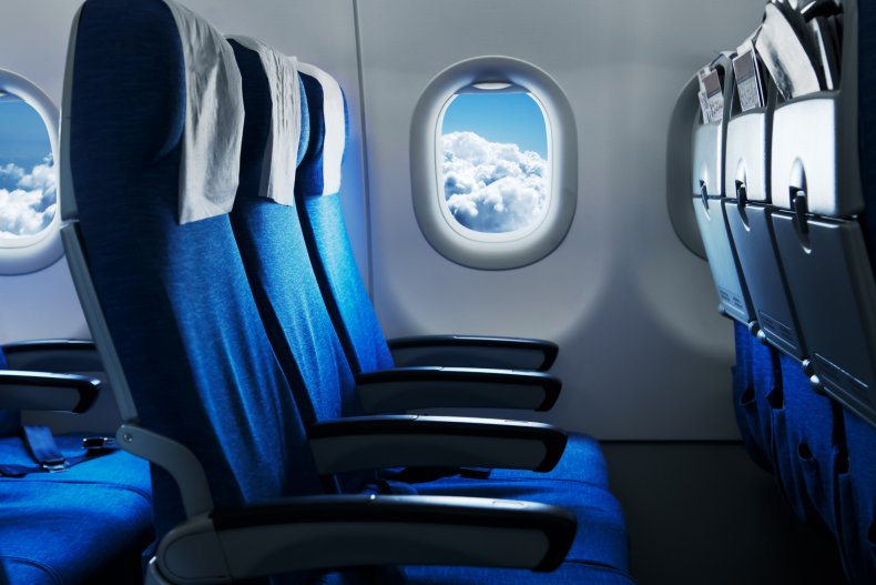 A view of empty, blue-colored passenger seats.