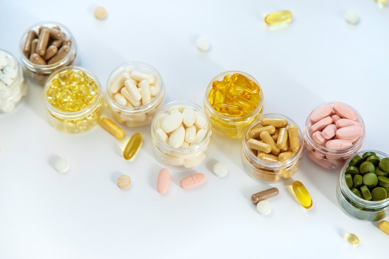 Containers of vitamin supplements on a table.