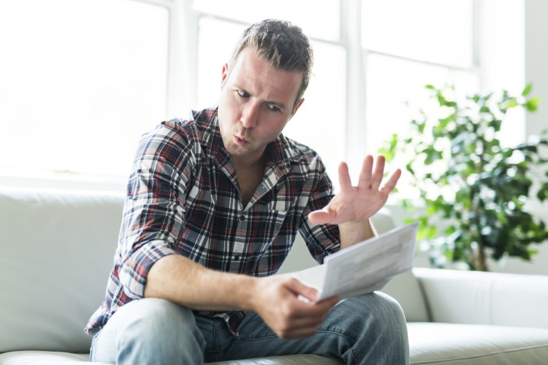A horrified man reading a letter