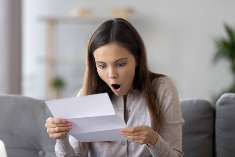 A  shocked woman reading a letter