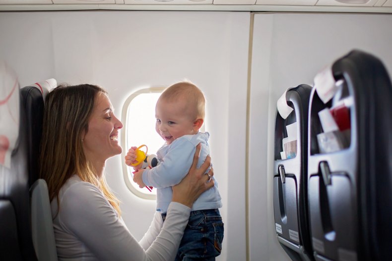 Woman holding a baby on a plane. 