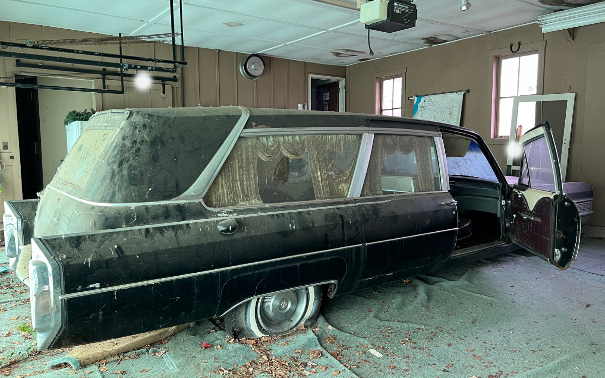 An abandoned funeral hearse. 