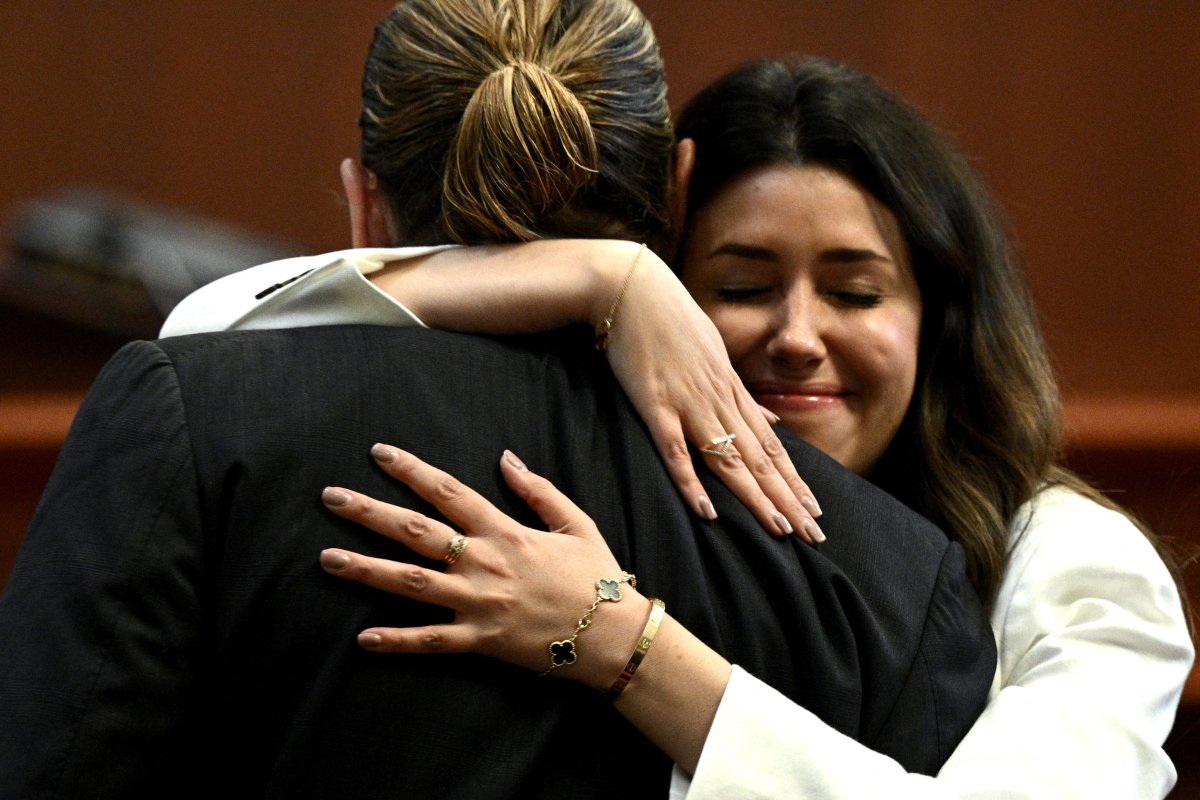 Camille Vasquez embraces Johnny Depp in court