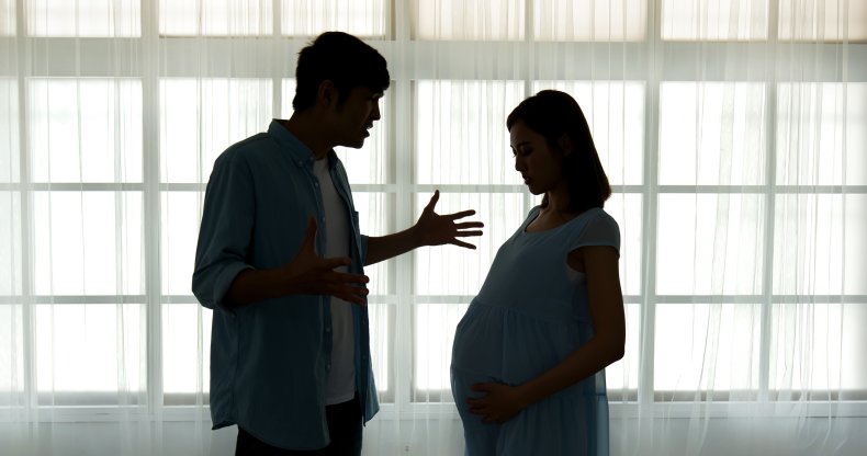 A man yelling at a pregnant woman