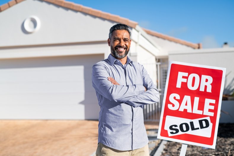 Stock image of man outside sold home