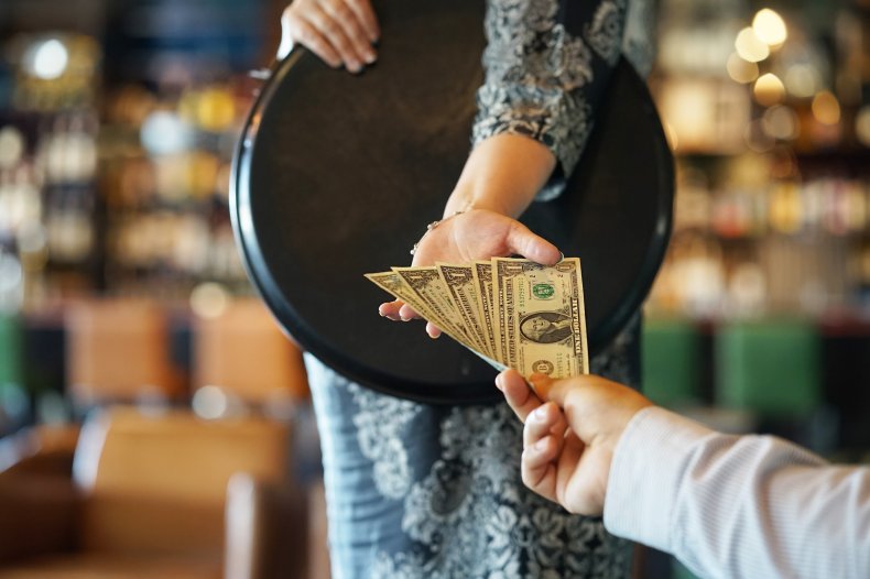 Woman receiving cash from customer. 