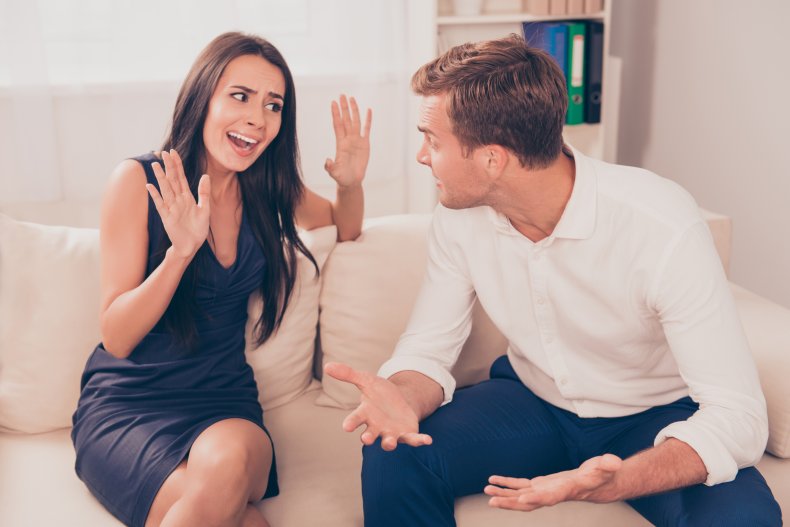 A couple arguing on a sofa