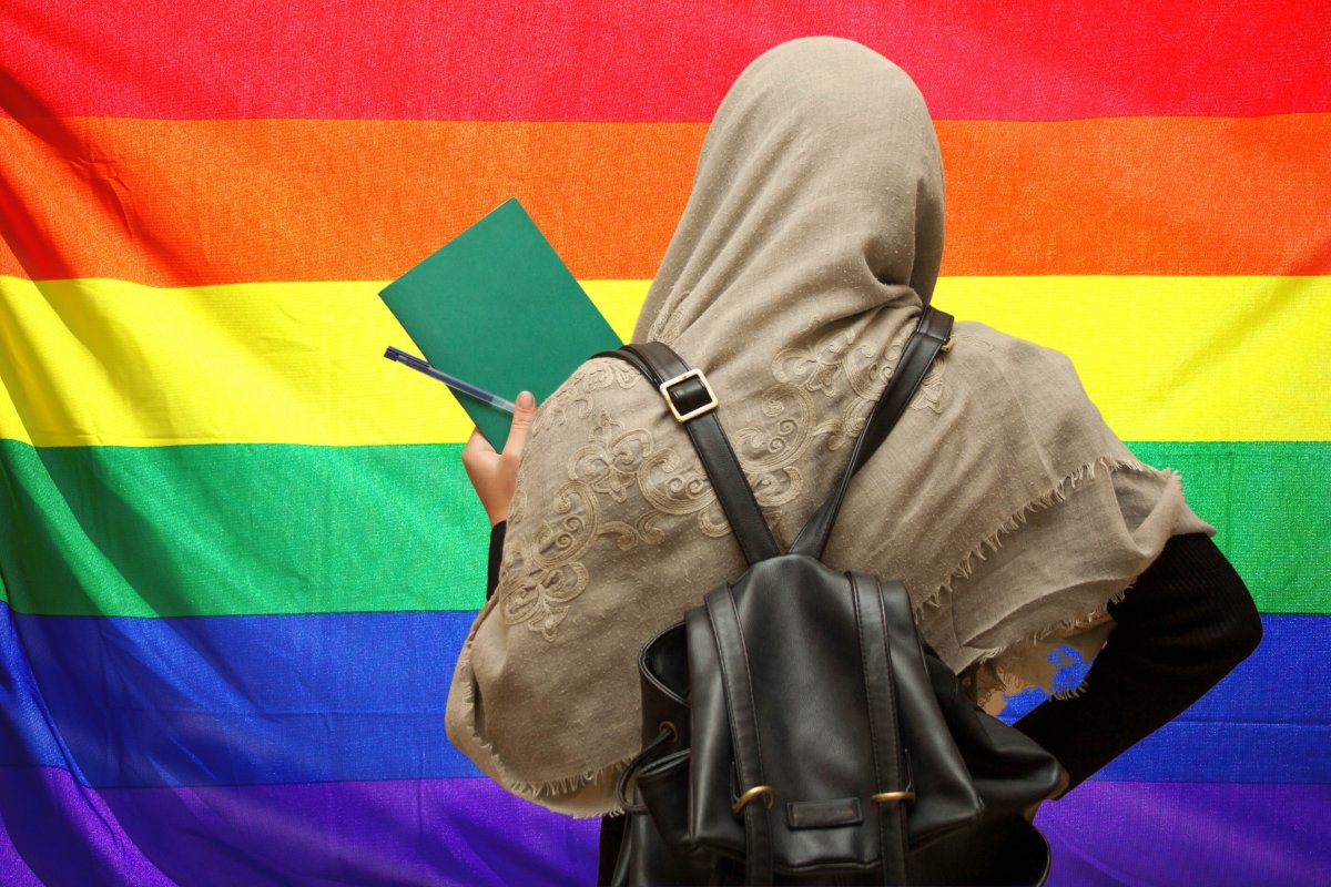 Muslim girl holding book rainbow flag