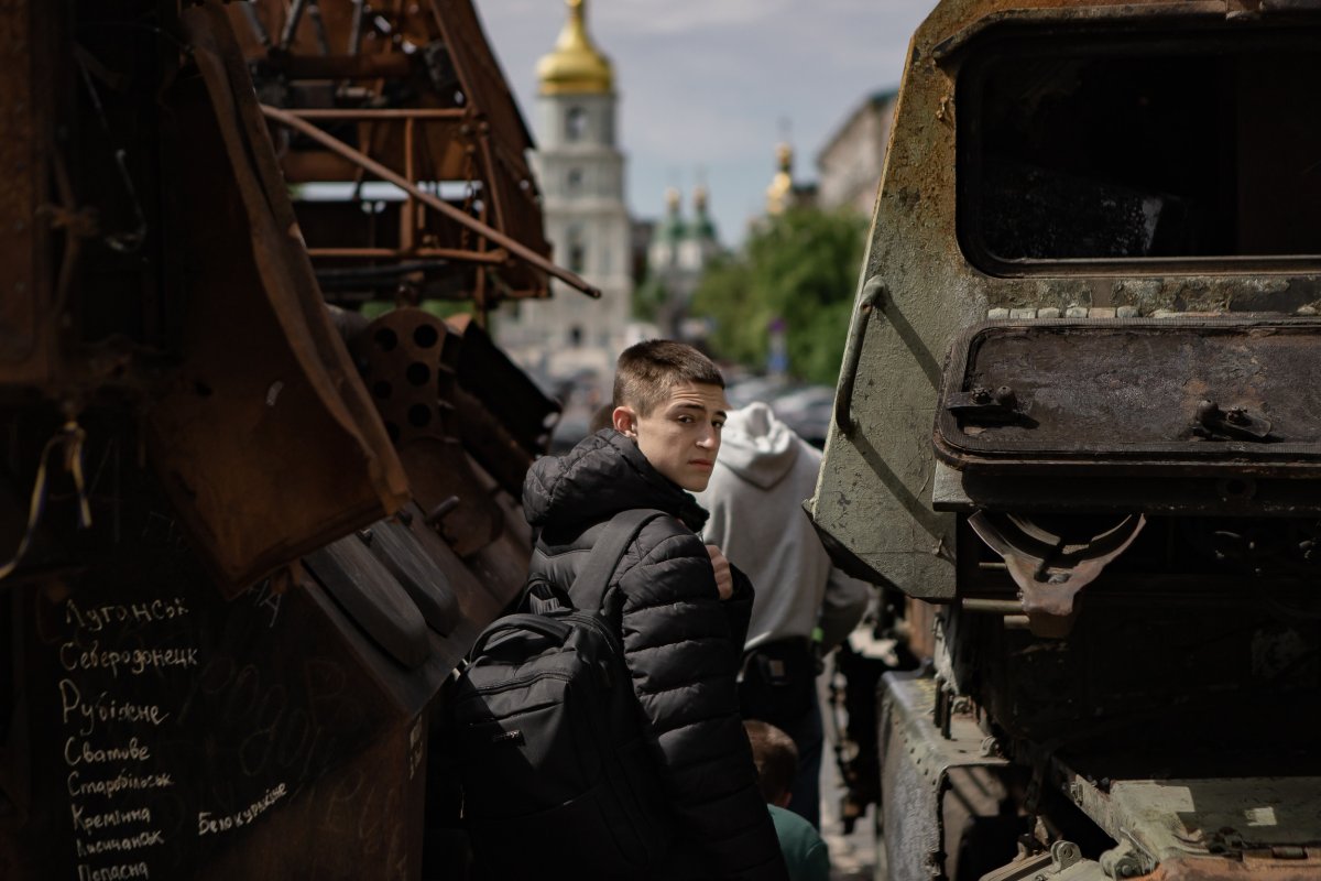 Boy pictured among destroyed Russian vehicles Kyiv