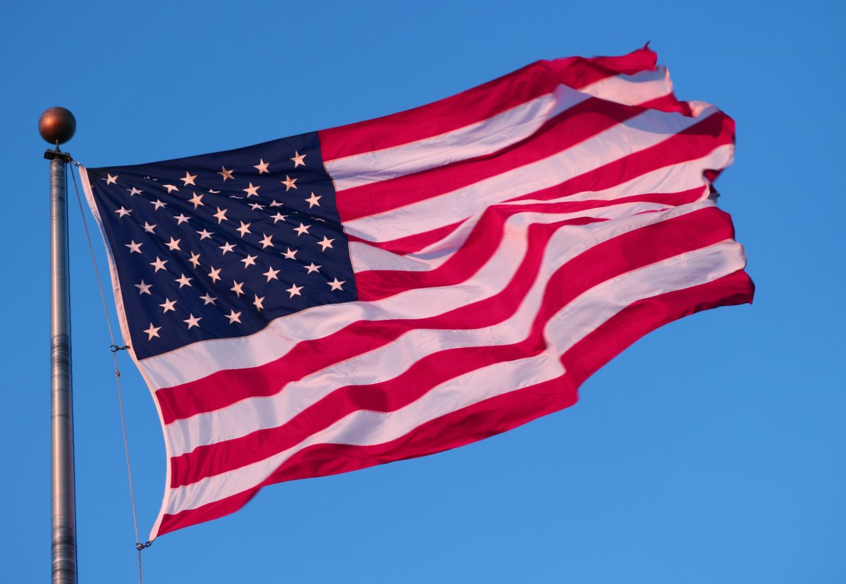 The sun sets on an American flag
