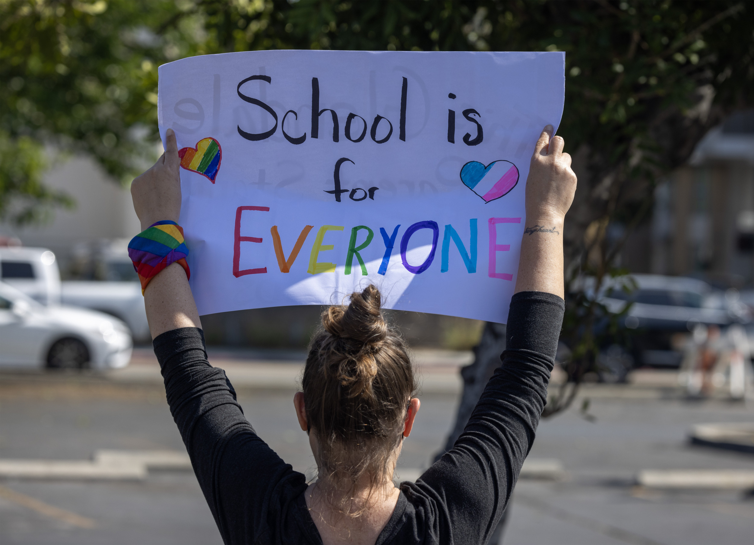 Pro-LGBTQ demonstrator holds sign