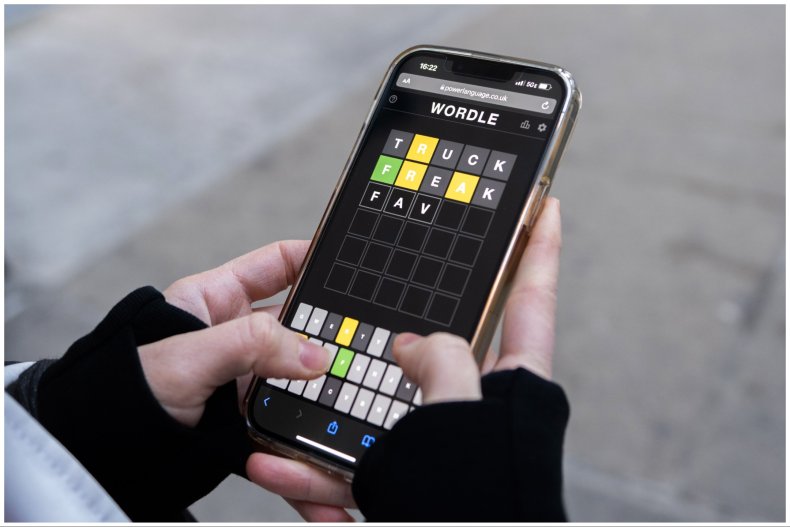 Woman playing Wordle on her phone