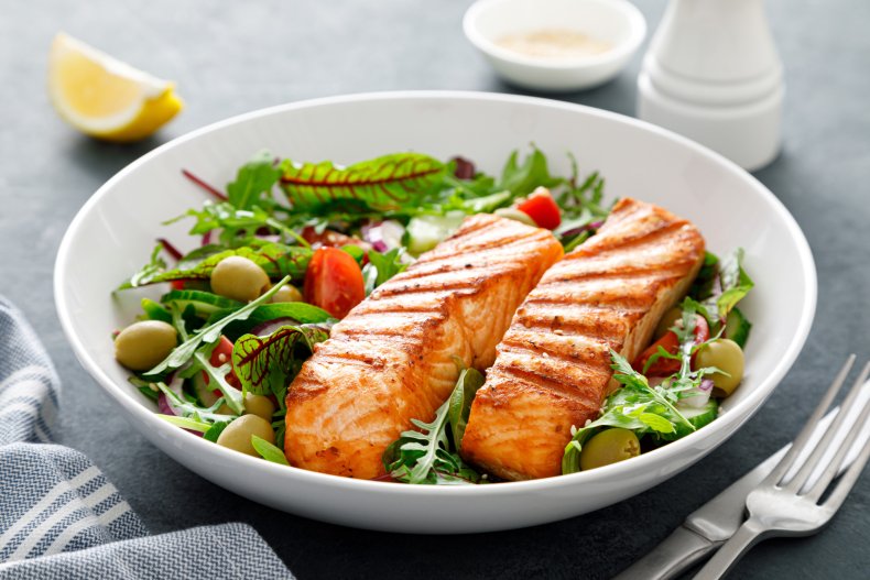Grilled salmon in bowl of salad.