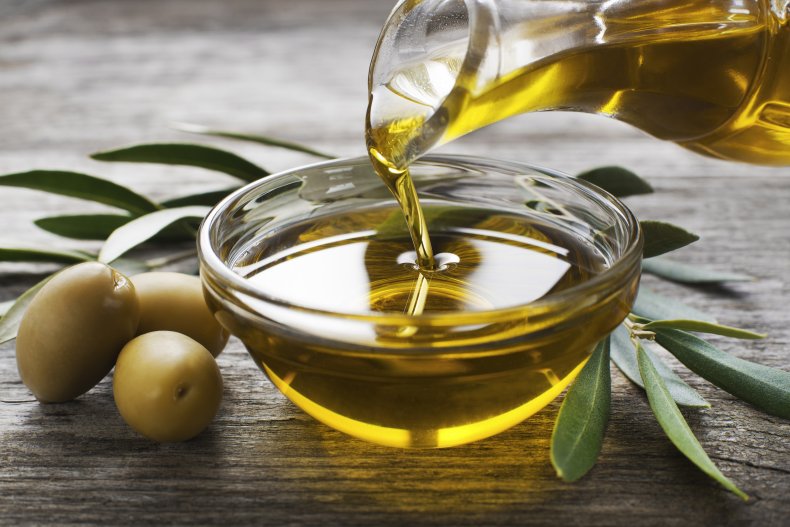 Olive oil being poured into bowl.
