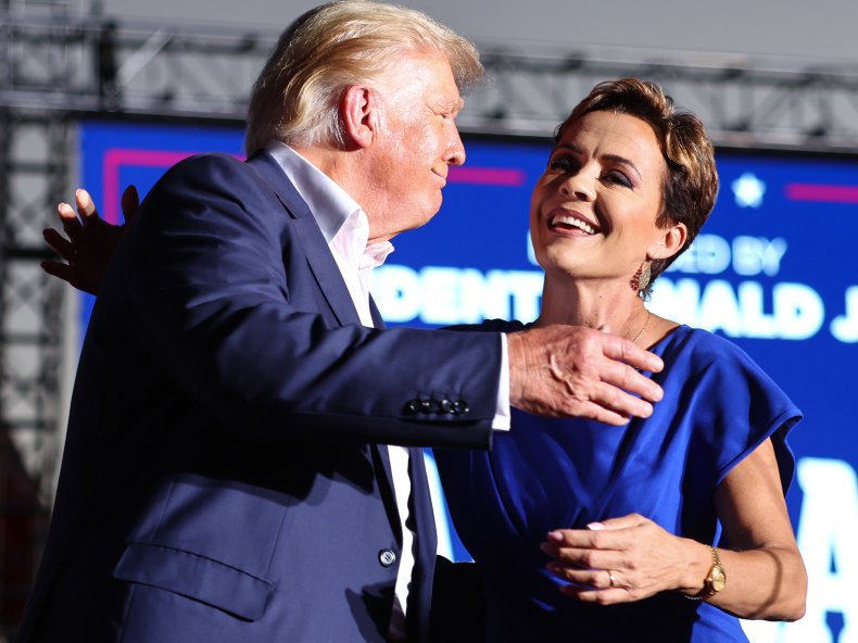 Former U.S. President Donald Trump embraces former
