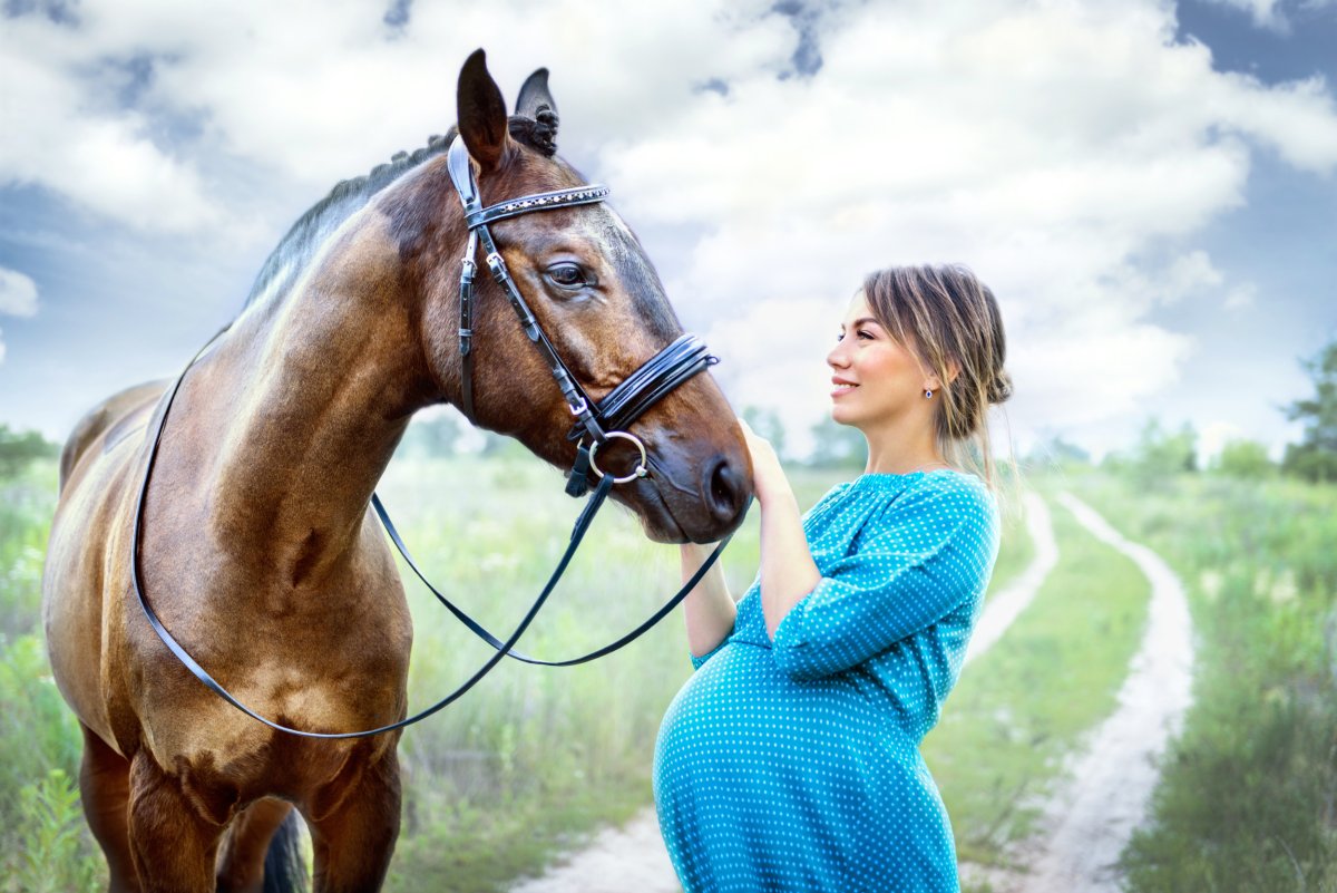 Woman and pregnant horse