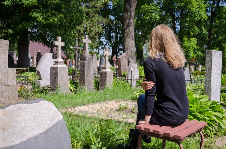 A woman visits a grave