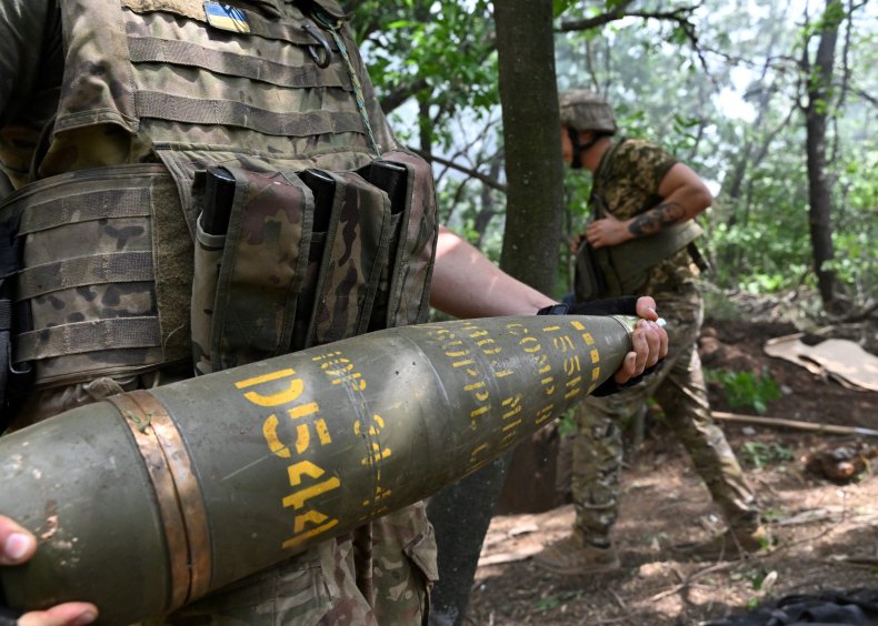 Ukrainian soldier with 155mm artillery shell
