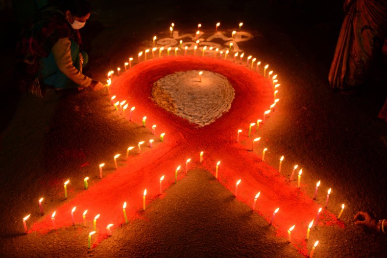 A volunteer lights candles