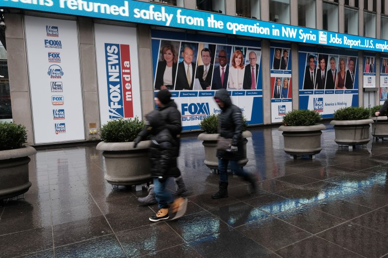 People walk past Fox headquarters