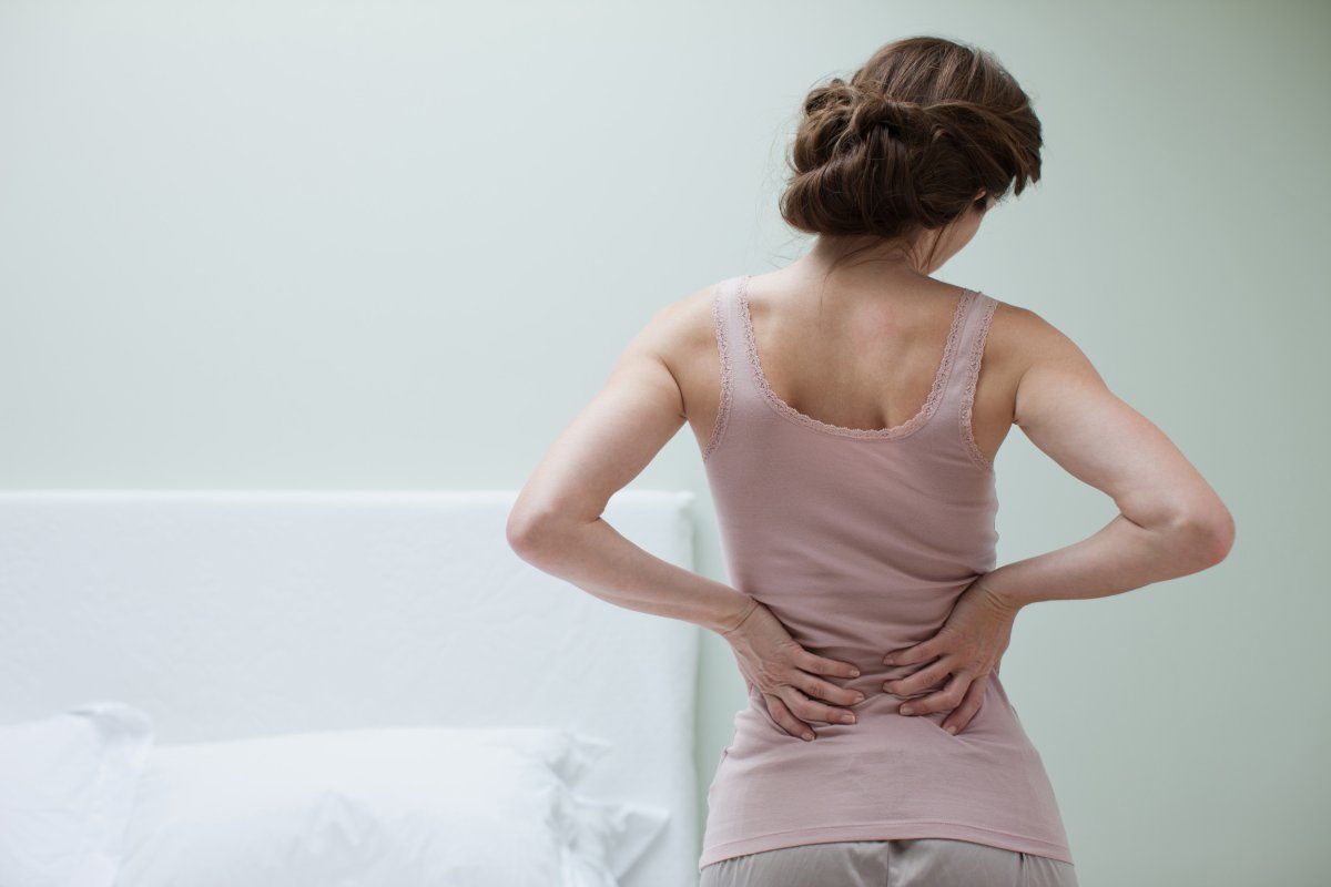 Woman grabbing back in pain.