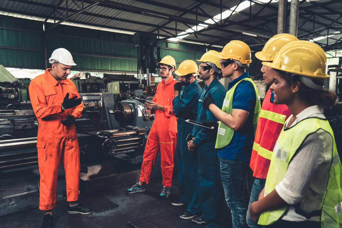 factory workers in hard hats