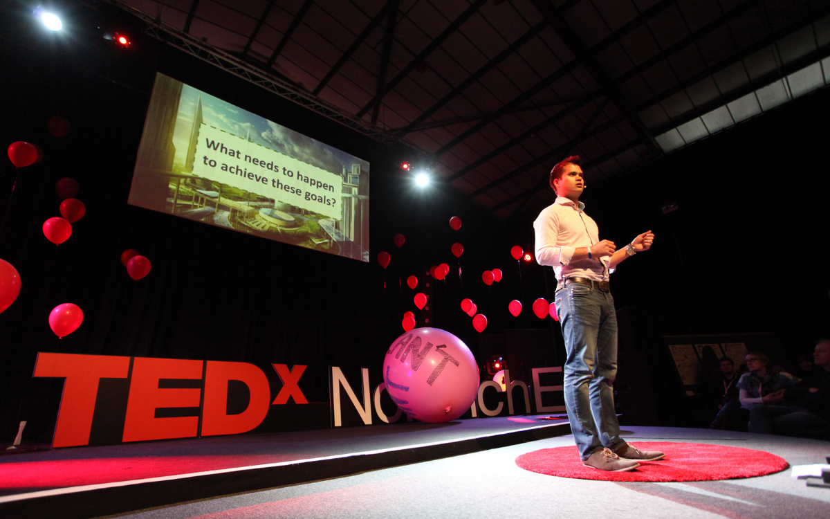 Siam delivering a Ted Talk.