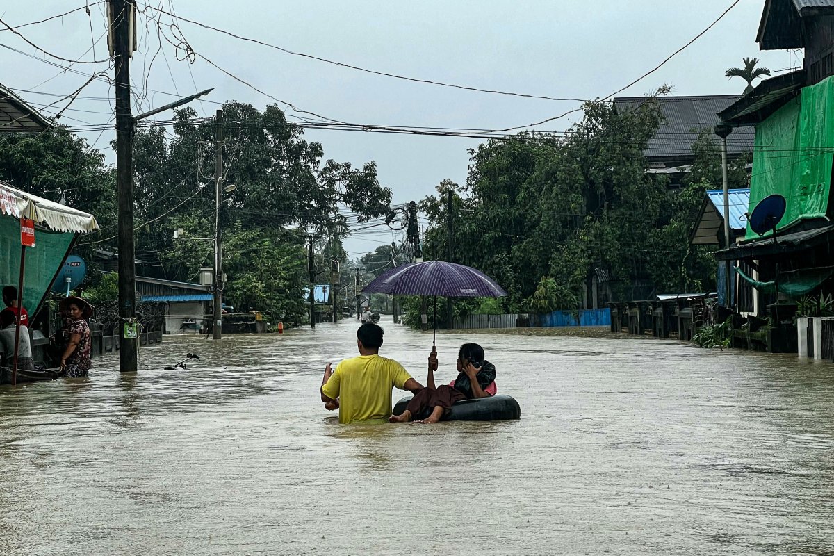 Residents move through a flooded street 